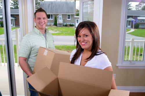 Professional movers loading household items for a Swiss Cottage relocation