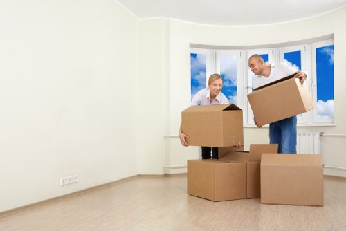 Local movers handling furniture through a Swiss Cottage apartment building