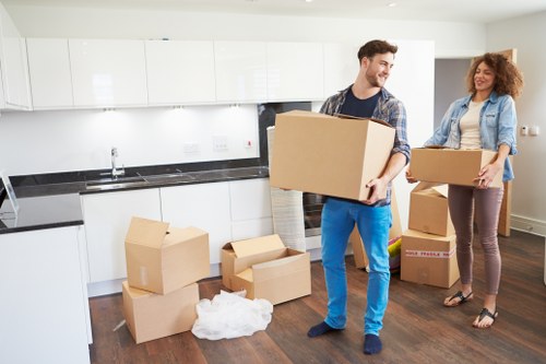 Packed moving boxes and furniture ready for transport in Swiss Cottage